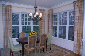 With a room full of windows and a beautiful view outside, we wanted to let nature be a highlight of this room. We installed an antiqued reeded rod with tightly shirred drapery panels to created our desired effect.