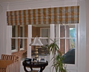 This homeowner wanted to use the same fabric in the sitting room as they used in the breakfast room, but they did not want to do drapery panels. So we came up with this design to immitate a functioning Roman Shade by making deep horizontal pleats and stitching them down.
