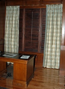 This luxurious plaid silk drapery is the perfect complement in a masculine study with wooden judges paneling. The hardware is a twisted bronze wrought iron and the draperies are lined, interlined and non-functional. They also have a 3" silk banding along the leading edge.