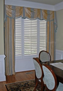 This wide stripe silk in a striking Bordeaux Valence and Drapery Panels fill an alcove in a formal dining room. The valence fabric had to be meticulously cut to ensure the stripes stayed on the vertical and emphasized a specific color stripe.