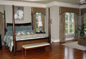 This homeowner wanted to have a master bedroom suite that reminded him of his visits to luxurious resorts. We created this look by using a silk strie fabric that has been lined and interlined. To bring a bit of whimsy we add rayon loop trim to the bottom of a traditionally shaped cornice.