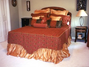 This is taken directly from a picture a client gave me from a Calico Corners Catelog. She loved the bedding so we re-created it with a custom shape on all three sides with gold braided cording that ran along the mattress top. The ensemble would not be complete without at least 13 pillows of many shapes and styles.