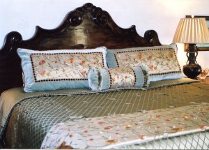 This bedding ensemble has lots of texture using a beautiful robin's egg blue/green fabric in the quilted bedspread. There is also velvet along the edges of the pillow shams and neck roll with a beautiful embroidered silk as the focal point. The throw is also fabricated from the embroidered silk.
